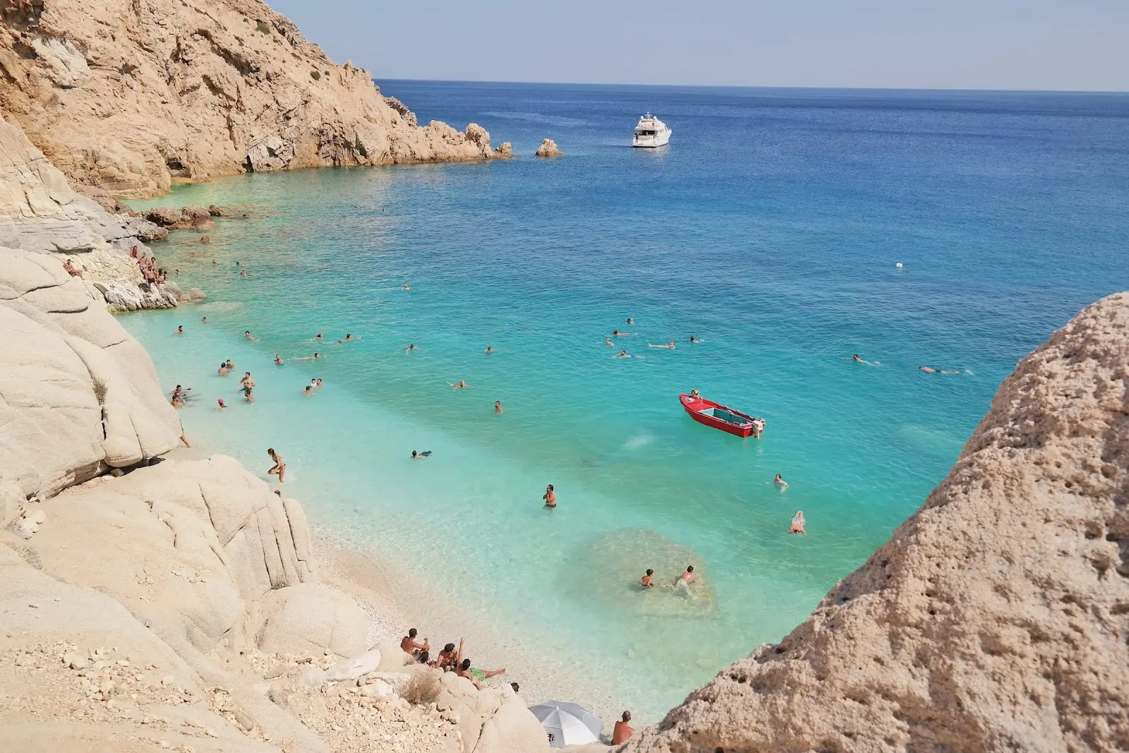 People enjoying the blue water on a perfect tropical beach.