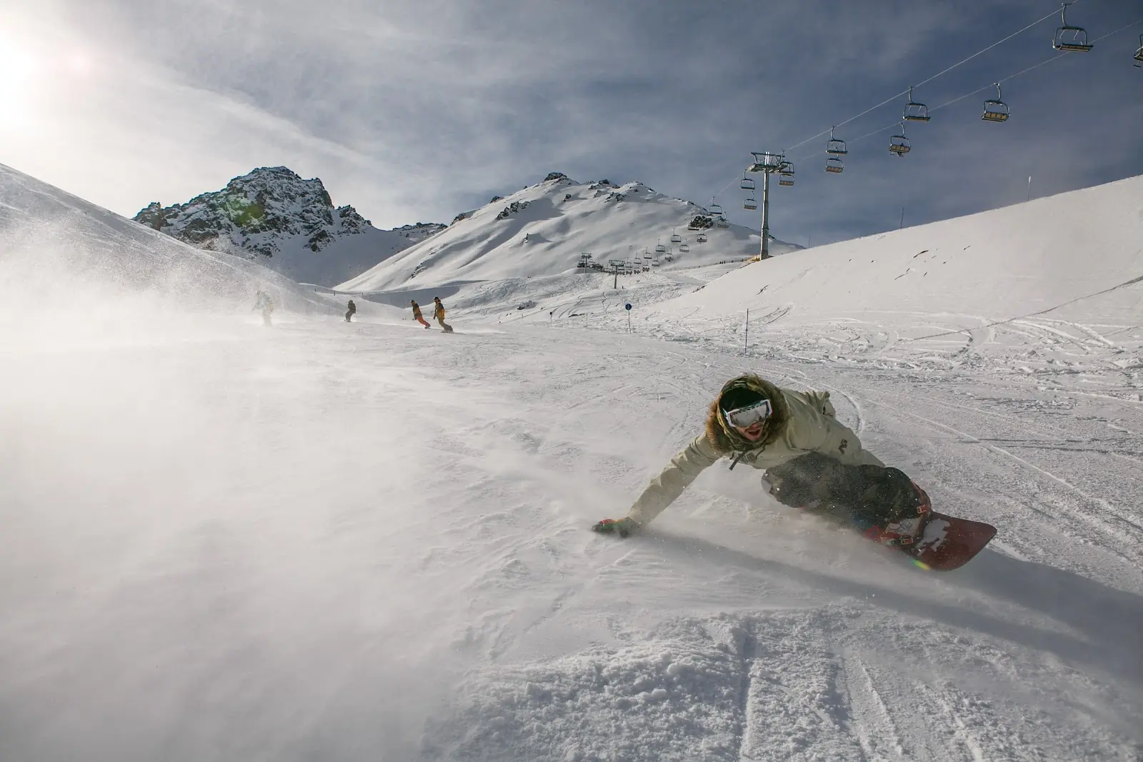 A man snow boarding on a mountain in Kazakhstan.