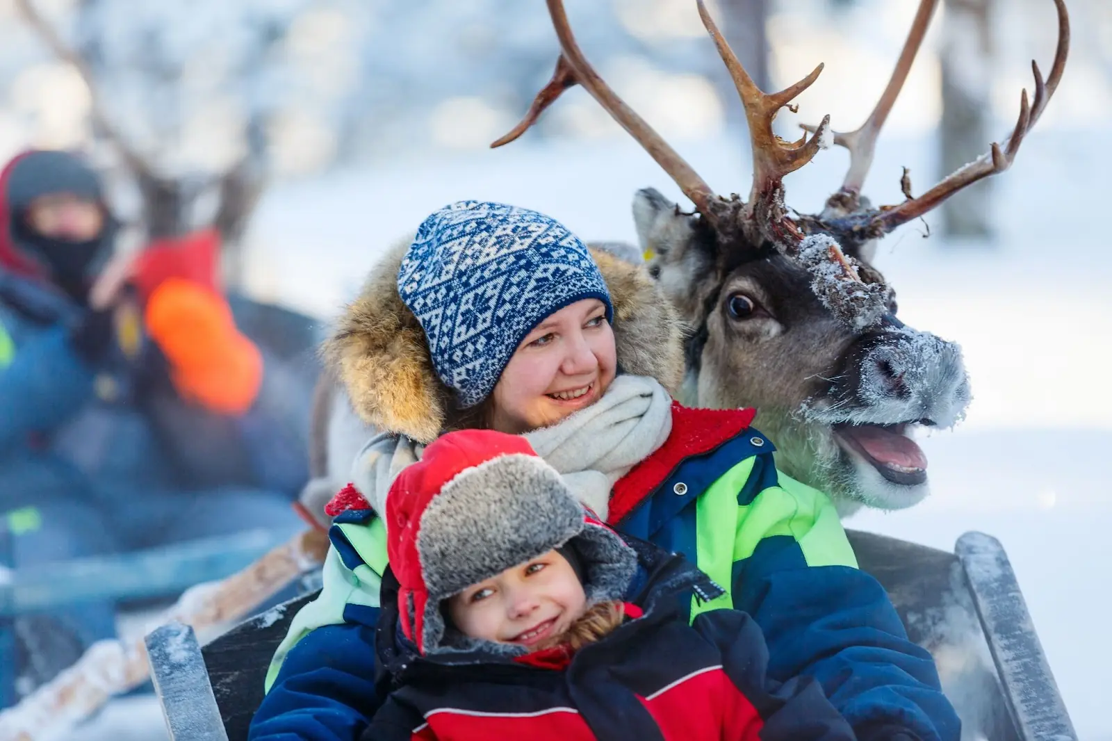 A mother and child ride a sledge in Norway. 