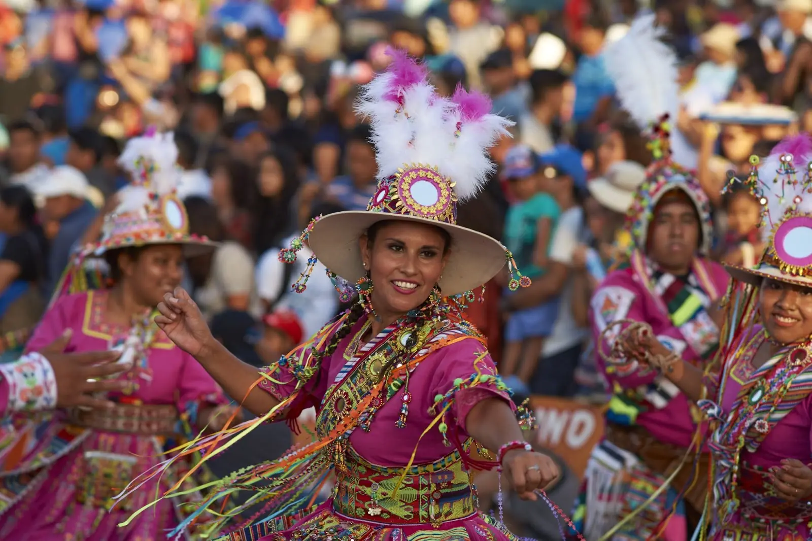 Tinku dancing group in colourful costumes performing a traditional ritual dance as part of the Carnaval Andino con la Fuerza del Sol in Arica, Chile.