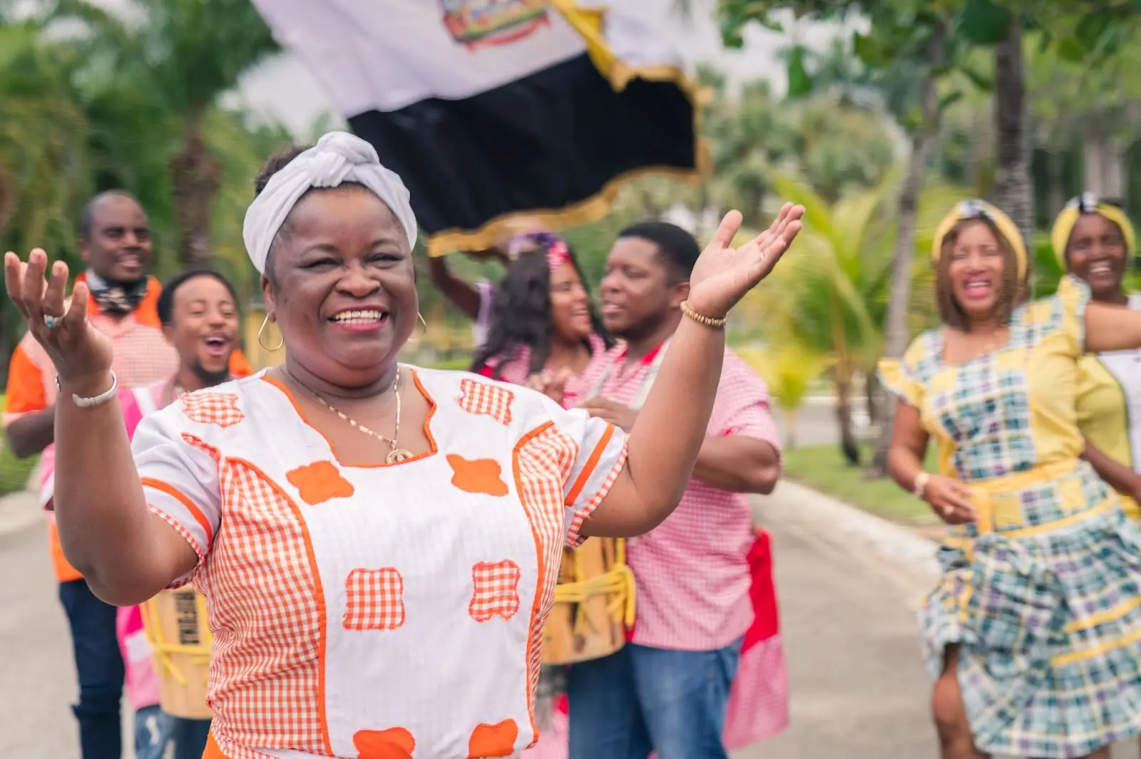 Haitian men and women dance in the park in traditional dress