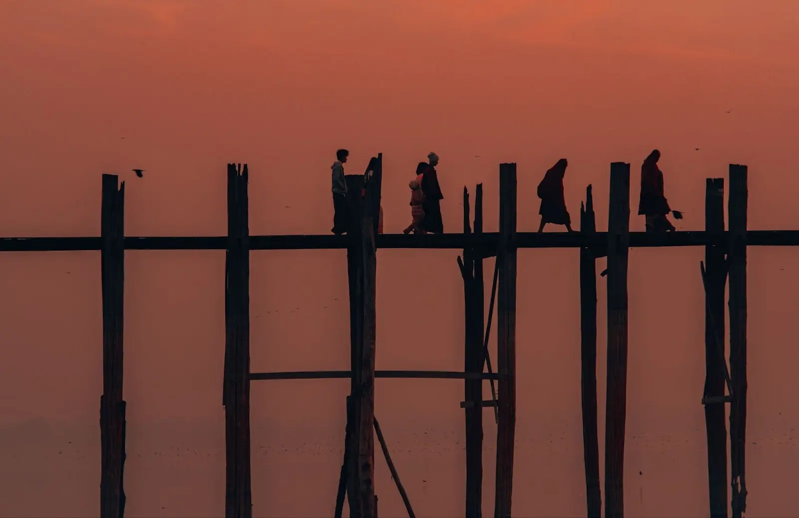 Locals walking across the U Bein Bridge