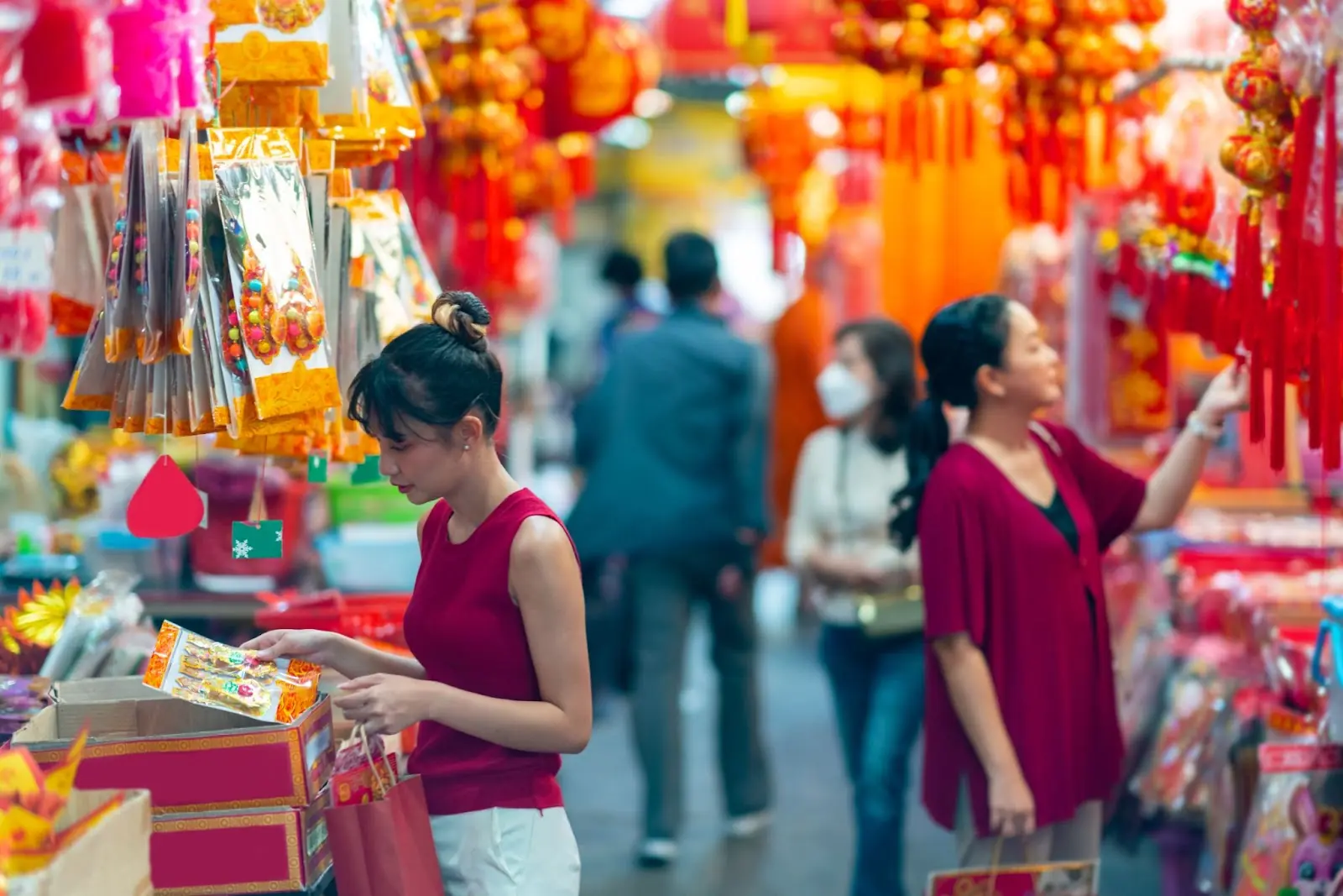 Locals buying decorative ornament for celebrating Chinese Lunar New Year festival at Bangkok Chinatown street market. 