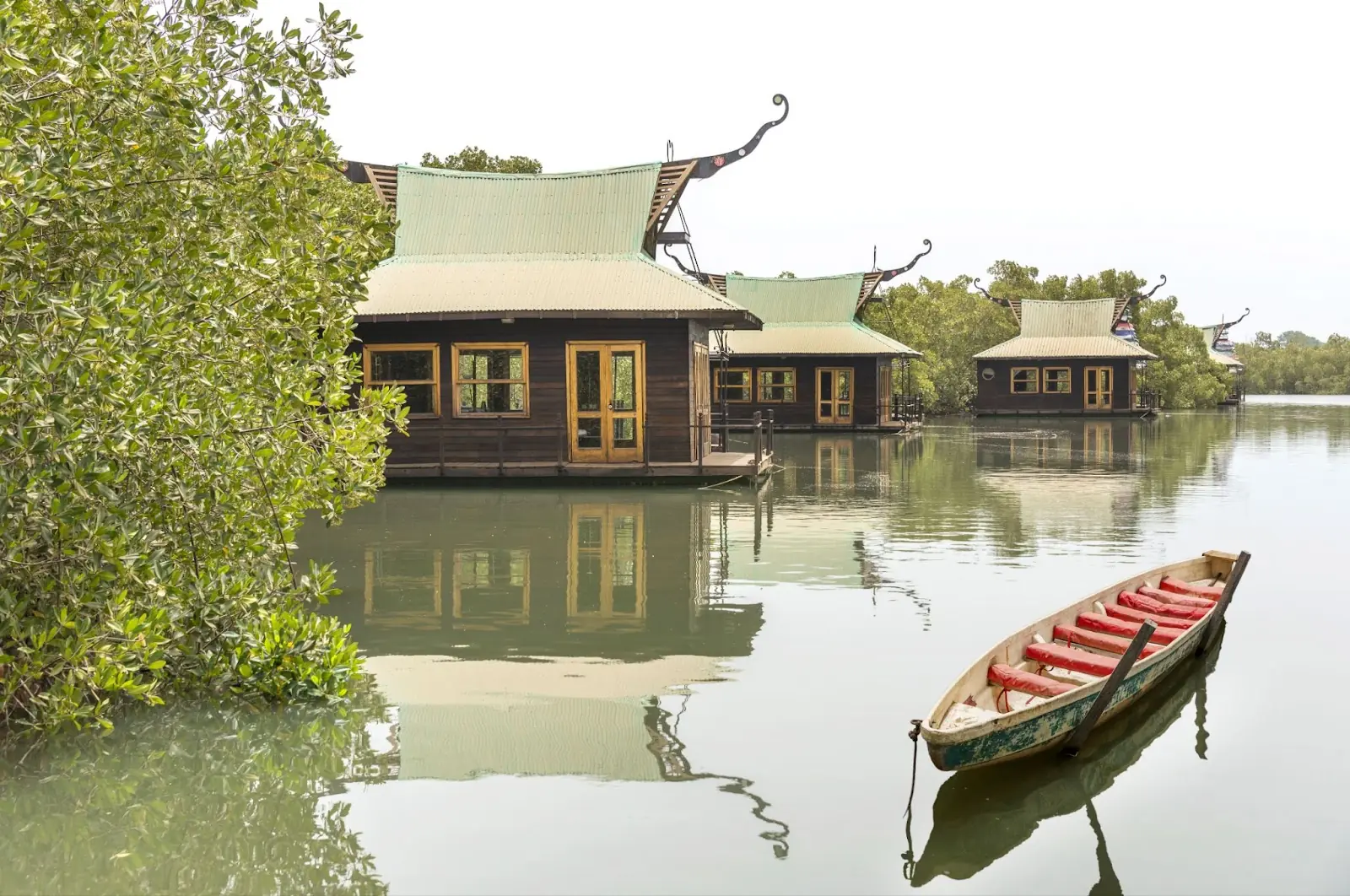 Houses and canoe on the Gambia River, in the Makasutu area, The Gambia