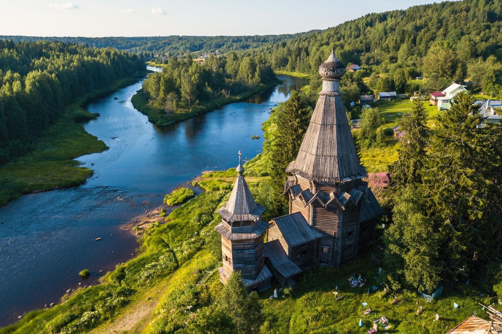 Bird's eye view of the Church of St. Nicholas (built 1696) in Soginicy village and Vazhinka river, Podporozhysky district. Green forests of Leningrad region and Republic of Karelia, Russia.