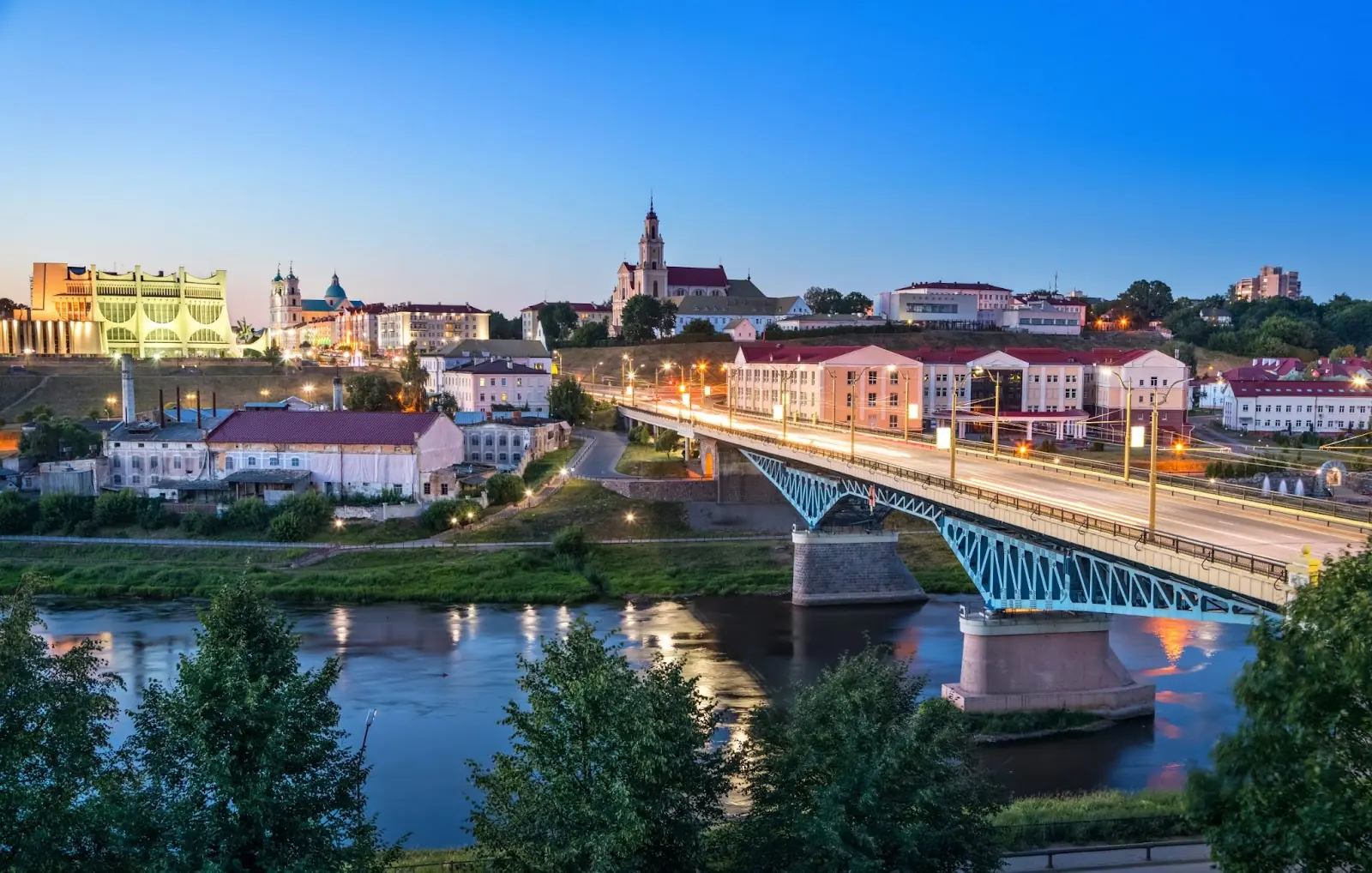Cityscape of Grodno at dusk with bridge over Neman river, Belarus.