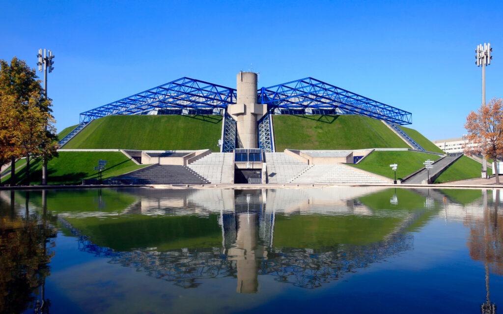 Bercy indoor arena for sports and entertainment events in Paris, France across the pond with reflection. Modern architecture inspired by ancient Egyptian pyramids.