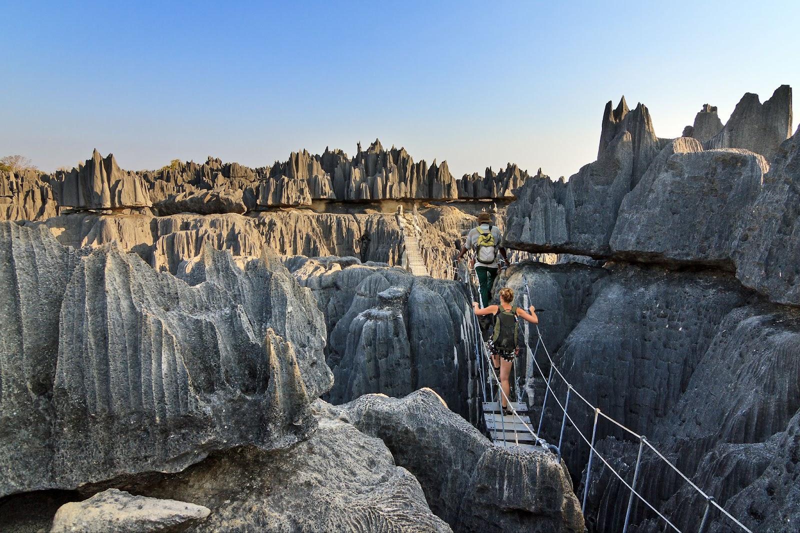 Beautiful tourist on an excursion in the unique limestone landscape at the Tsingy de Bemaraha Strict Nature Reserve in Madagascar.