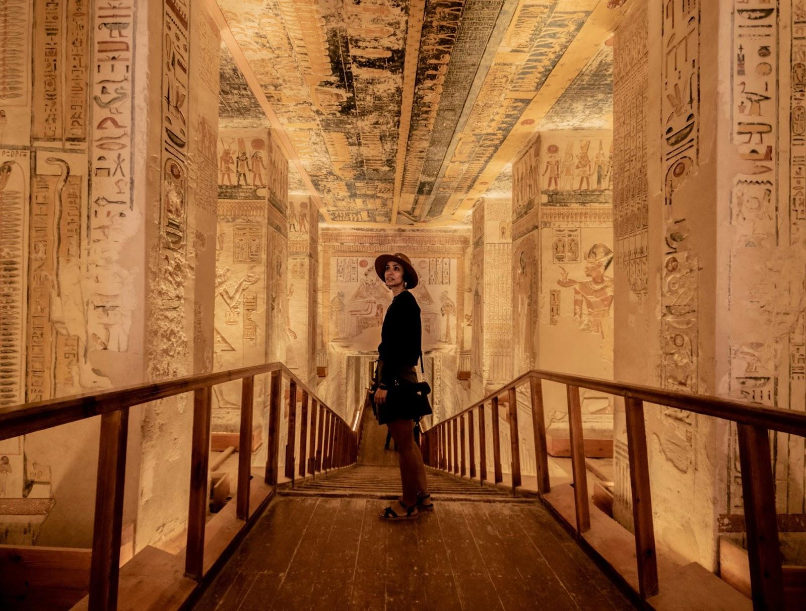 Woman stood inside one of the tombs of the pharos paid by for converting GBP to EGP before travel 