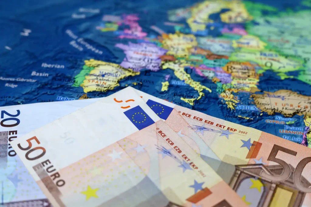 Euro banknotes on the Europe map. Concept of Eurozone, European economy, EU financial support