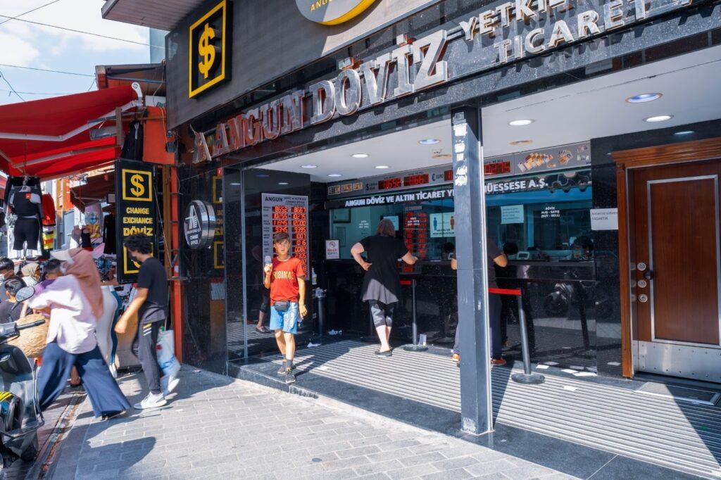 exterior view of Turkish exchange office and some people change deposit cash or convert money in bureau de change in a sunny day