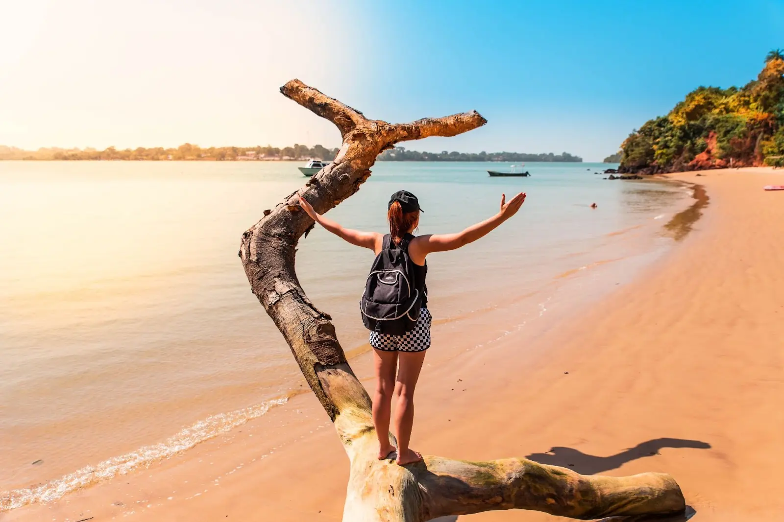 Happy girl stands on a paradise beach in West Africa