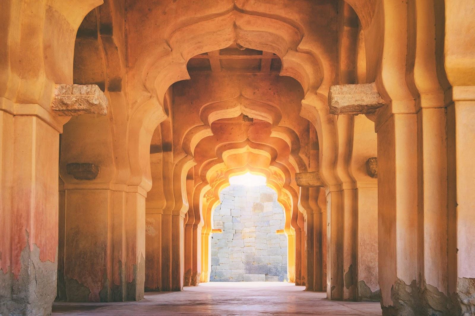 Old ruined arch of Lotus Mahal at sunset, Hampi, Karnataka, India.