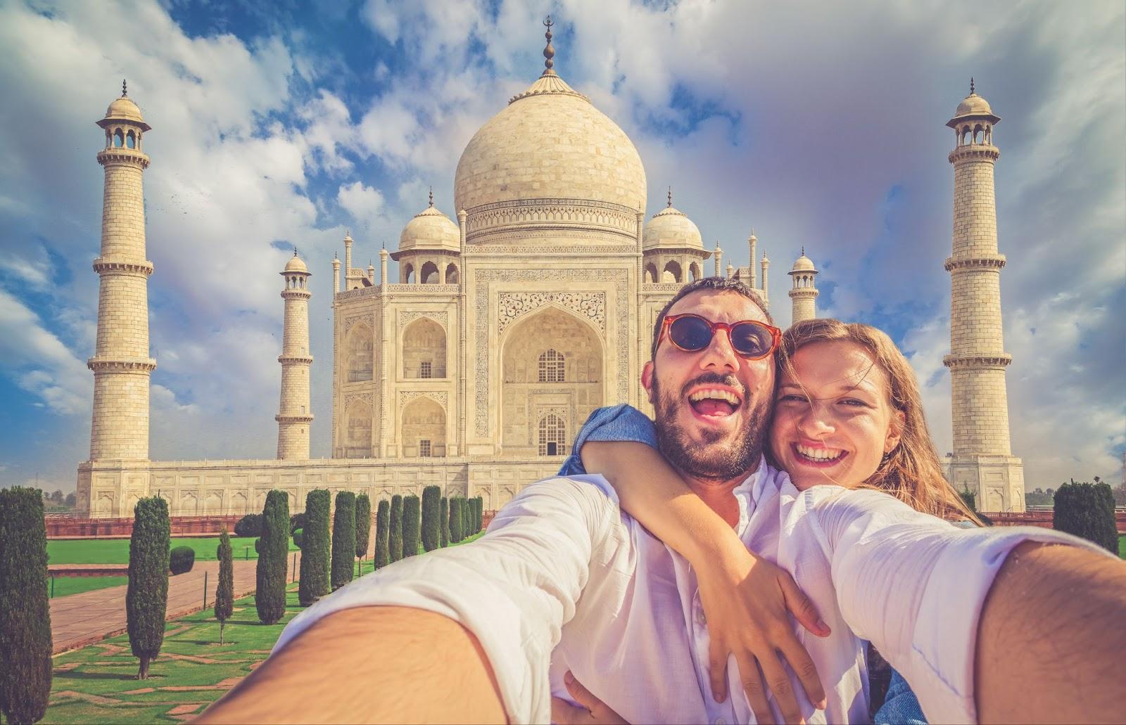 couple in love in holiday using mobile phone to take selfie picture at Taj Mahal, Agra, Uttar Pradesh, India.jpg