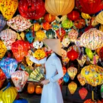 Asian woman wearing vietnam culture traditional and hoi an lanterns at Hoi An ancient town, Vietnam.