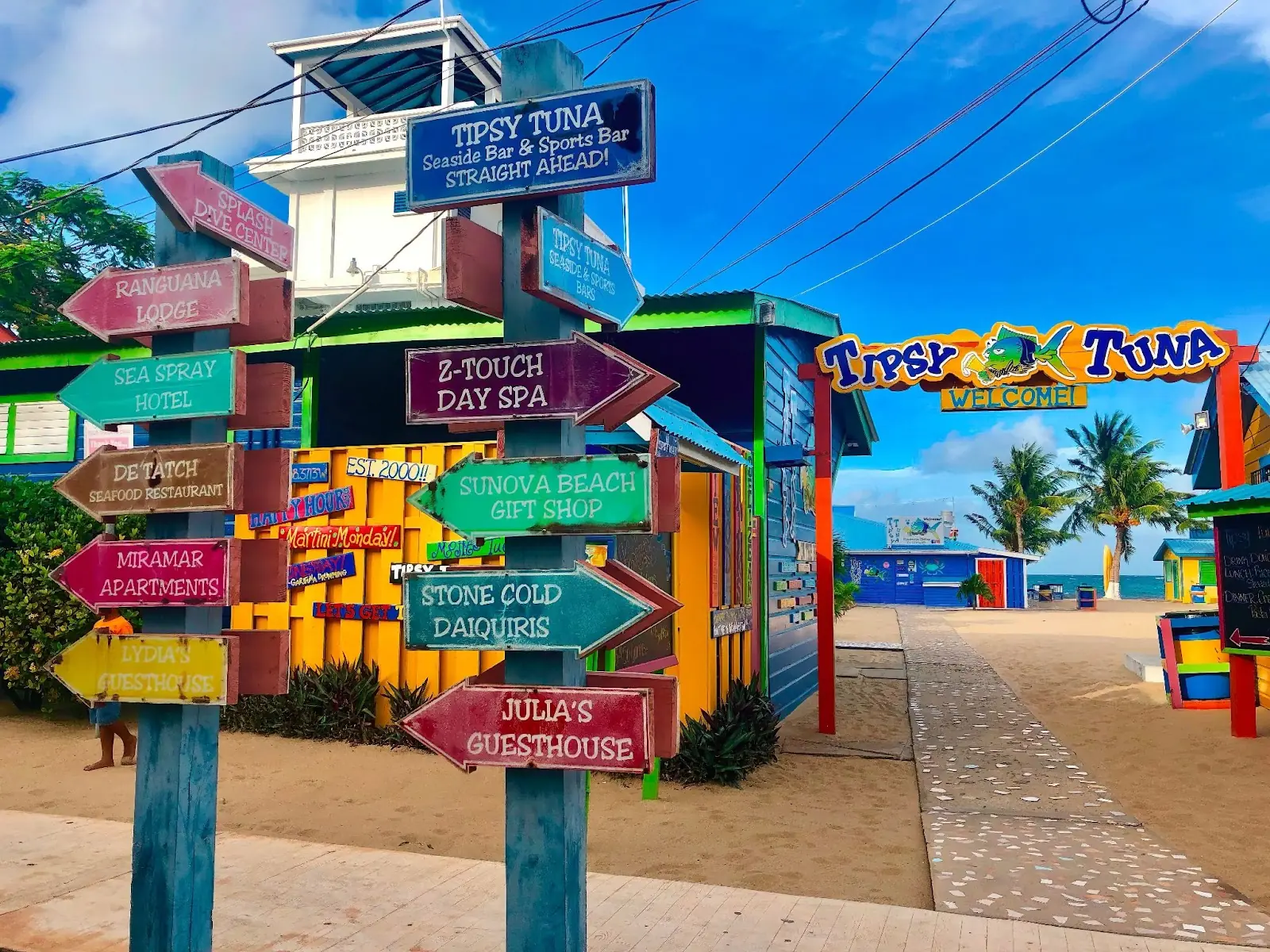 Colorful street sign on the beachfront Sidewalk outside the Tipsy Tuna bar.