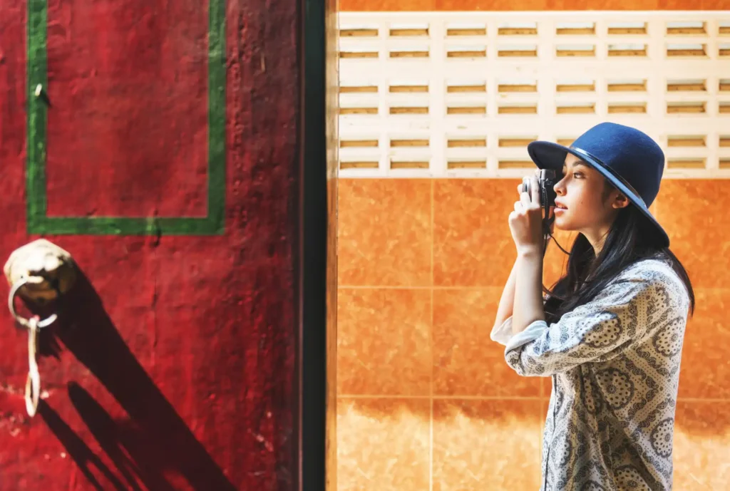 The solo Asian female traveller taking a picture on her camera