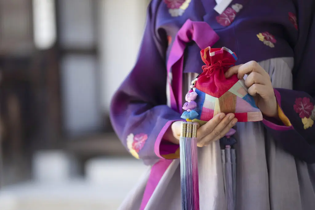 Woman wearing Korean traditional clothes with lucky bag