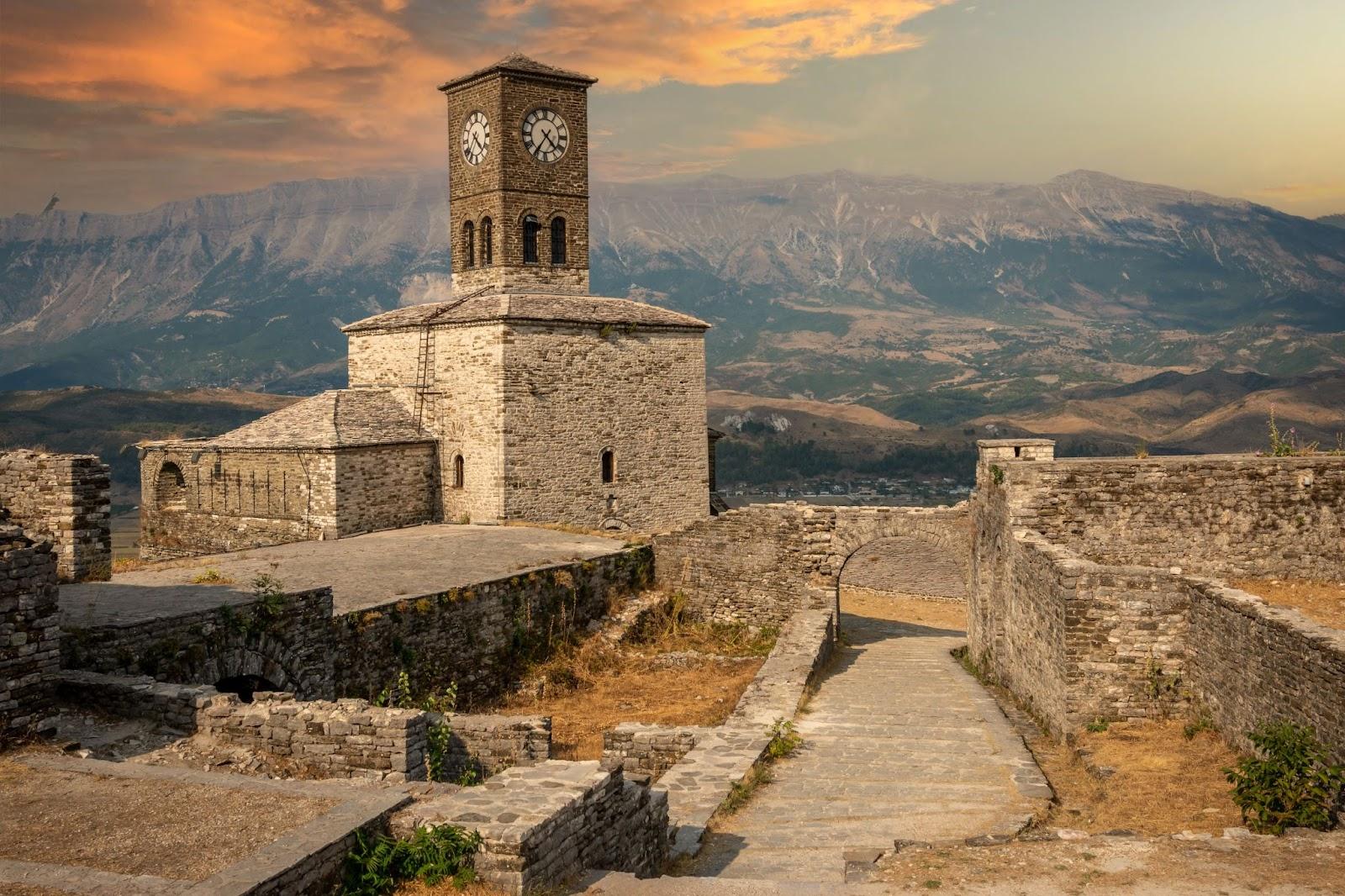 Sunset over clock tower and fortress at Gjirokaster