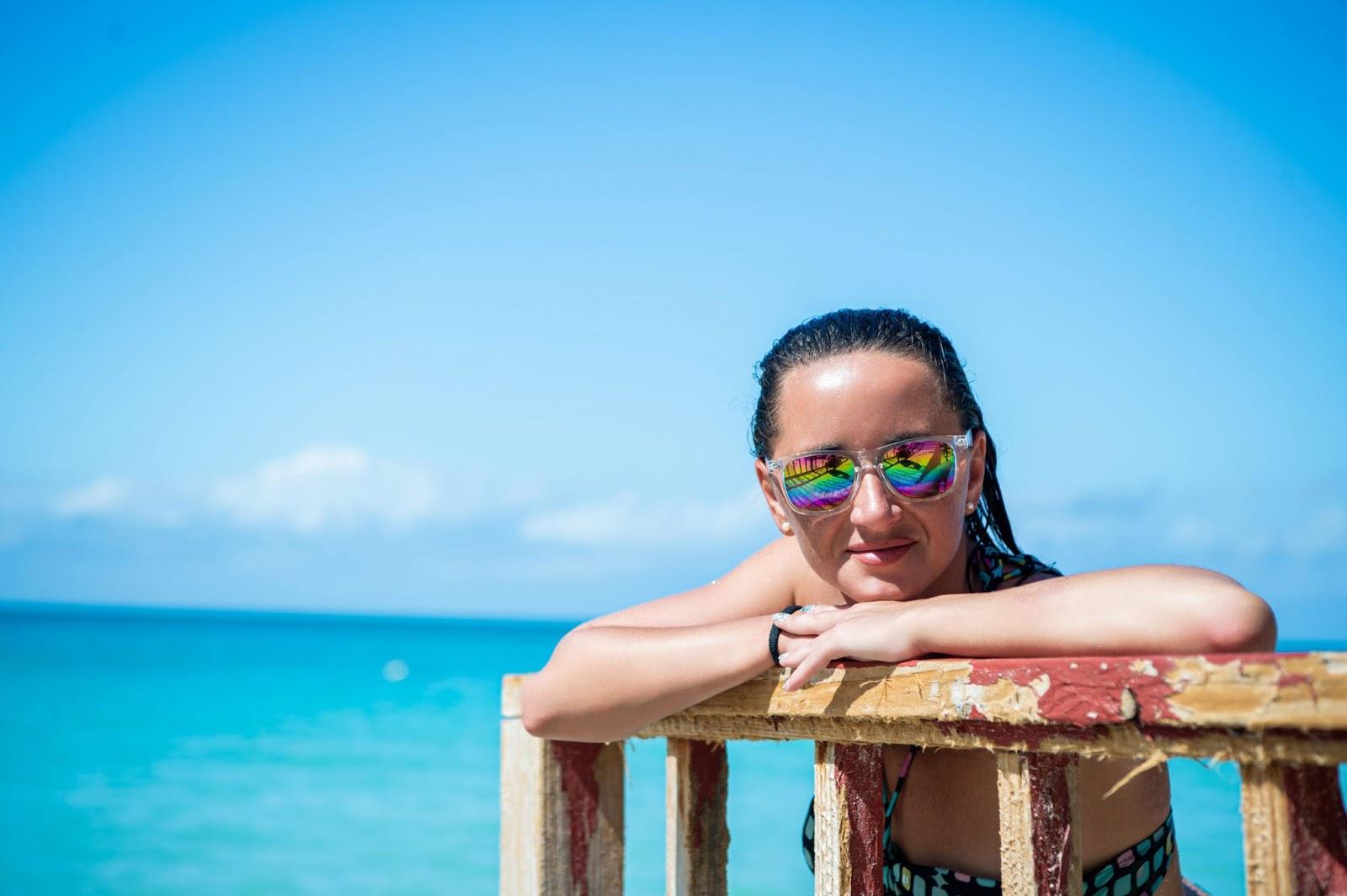 Woman wearing sunglasses on a beach