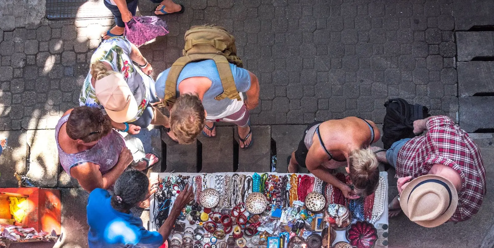 Several tourists looking at souvenirs on the market in Victoria