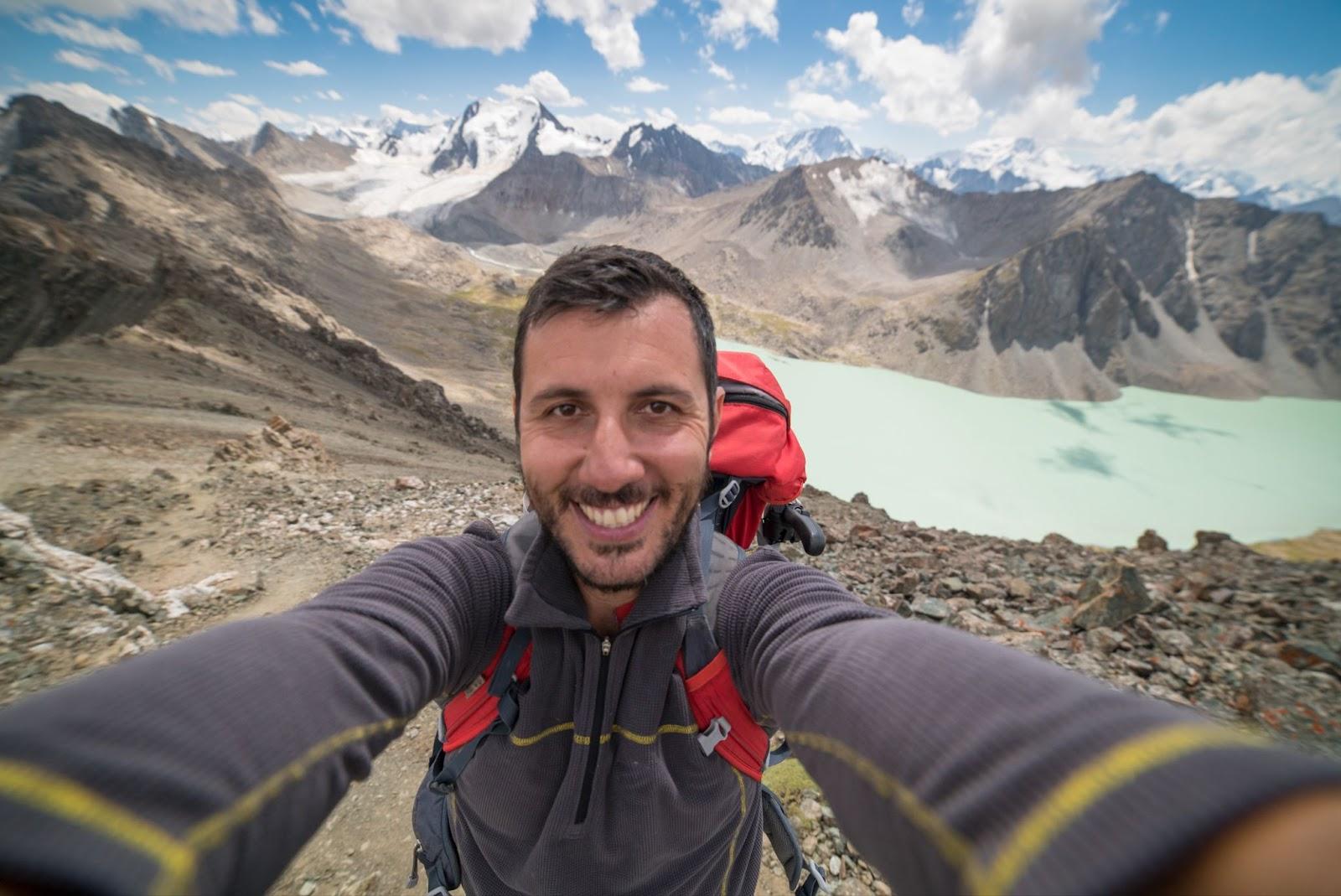 happy man take selfie in Ala Kul lake