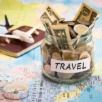 Travel budget concept. Travel money savings in a glass jar with compass, passport and aircraft toy on world map