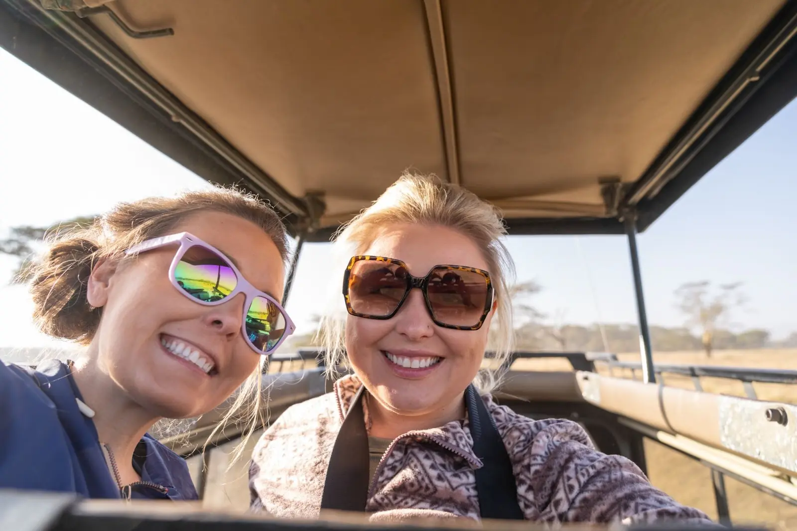 Two women on safari take a selfie.  They got their currency at the mid market rate.   