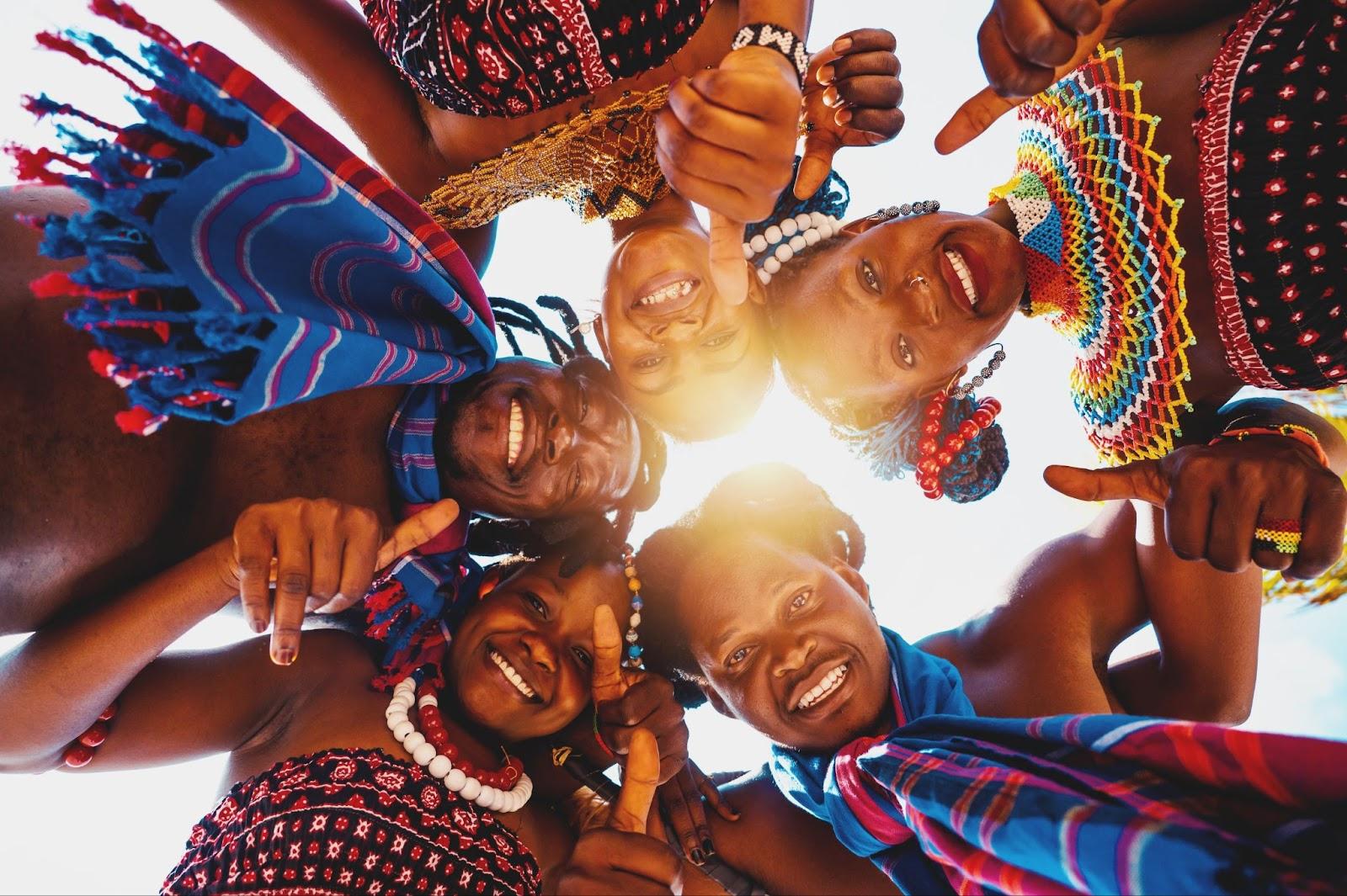 Local people with typical kenyan clothes hug and smile together